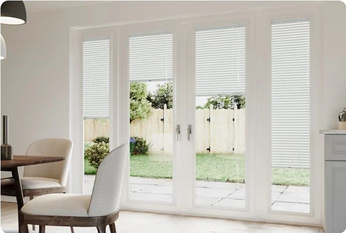 White slatted blinds on patio doors in a dining room